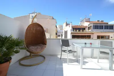 a balcony with a table and chairs on a roof at Viva Sitges - Mayo Terrace in Sitges