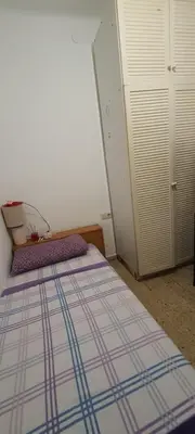 a bedroom with a bed and a white door at Estudio, privado e independiente in Hospitalet de Llobregat