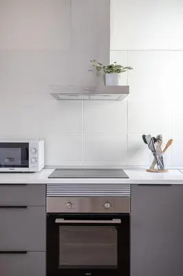 a kitchen with a stove and a microwave at Modern 1 bedroom apartments near Parallel in Barcelona