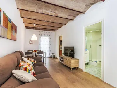 a living room with a couch and a television at Apartment Eixample Dret Aragó Roger de Lluria by Interhome in Barcelona