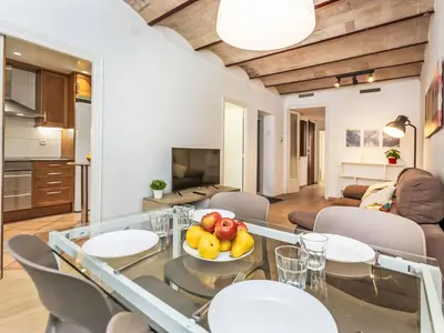 a living room with a glass table with fruit on it at Apartment Eixample Dret Aragó Roger de Lluria by Interhome in Barcelona