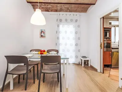 a kitchen and dining room with a table and chairs at Apartment Eixample Dret Aragó Roger de Lluria by Interhome in Barcelona