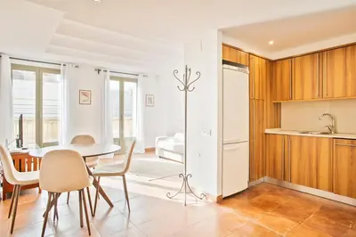 a kitchen and dining room with a table and chairs at Alcam Dali in Barcelona