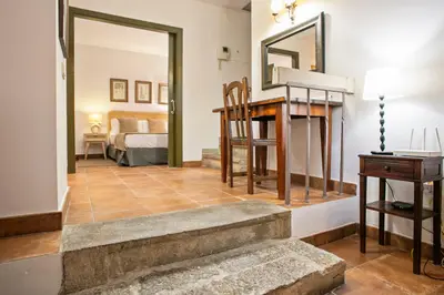 a living room with a staircase and a bedroom at Alcam Dali in Barcelona