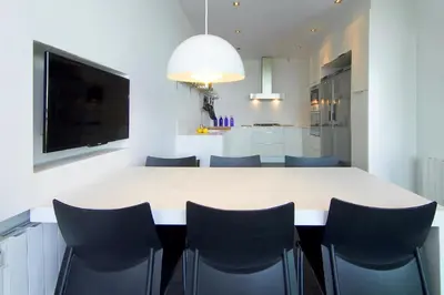 a kitchen and dining room with a white table and chairs at Holiday Home Alexander Plana in Pallejá