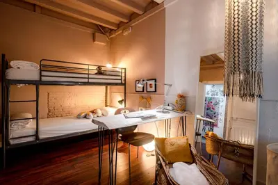 a bedroom with a desk and bunk beds at Canela Homes BARCELONA PERMANYER in Barcelona