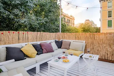 a white couch sitting on a patio with a table at Canela Homes BARCELONA PERMANYER in Barcelona