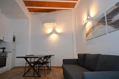 a living room with a couch and a table at Homenfun Dalt Badalona in Badalona