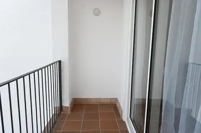 a hallway with a glass door and a tile floor at Homenfun Dalt Badalona in Badalona