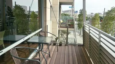 a balcony with two chairs and a glass table at Torre Forum in Sant Adria de Besos