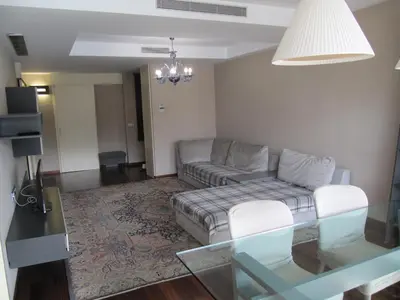 a living room with a couch and a glass table at Torre Forum in Sant Adria de Besos