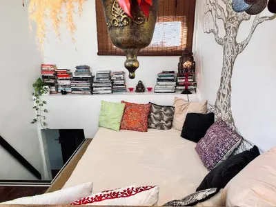 a couch with pillows on it in a room at Diamond Rooftop & private terrace sea views in Barcelona