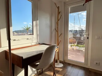a dining room with a table and a window at Diamond Rooftop & private terrace sea views in Barcelona
