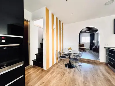 a kitchen and living room with a table and chairs at Diamond Rooftop & private terrace sea views in Barcelona