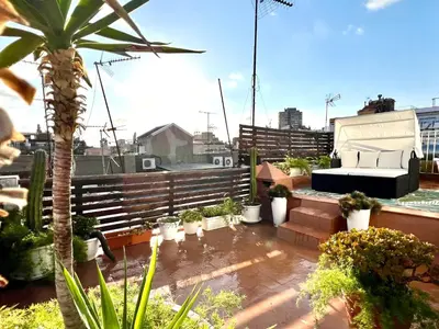 a balcony with plants and a couch on a roof at Diamond Rooftop & private terrace sea views in Barcelona