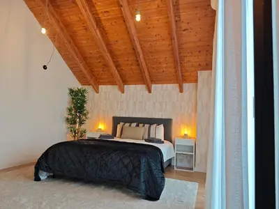 a bedroom with a bed and a wooden ceiling at Venecia relax in Vallirana