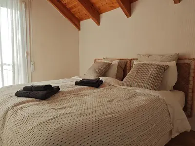 a bedroom with a large bed with two towels on it at Venecia relax in Vallirana