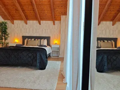 a bedroom with two beds and two tables with lamps at Venecia relax in Vallirana