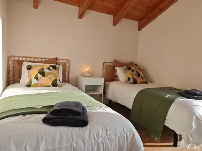 a bedroom with two beds and a lamp on a table at Venecia relax in Vallirana