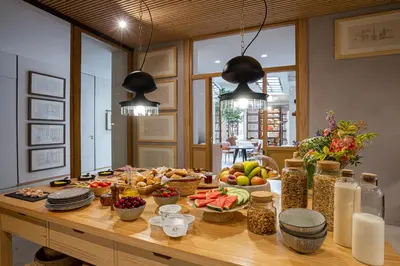 a table with fruits and other food on it at Hotel Margot House Barcelona in Barcelona