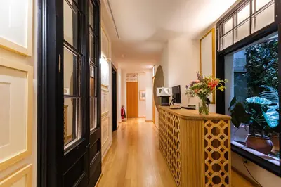 a hallway with a desk and a window at Hotel Margot House Barcelona in Barcelona