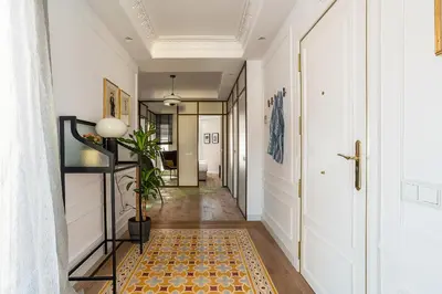 a hallway with white walls and a rug on the floor at Rental Apartment Barcelona in Barcelona