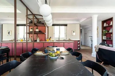 a dining room and kitchen with a black table and chairs at Rental Apartment Barcelona in Barcelona