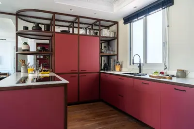 a kitchen with red cabinets and a large window at Rental Apartment Barcelona in Barcelona