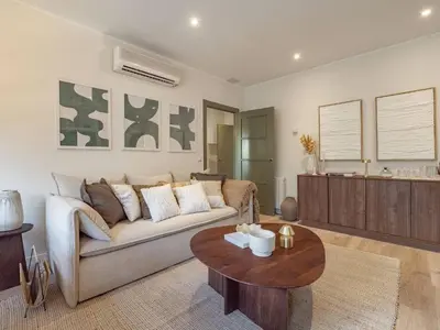 a living room with a couch and a table at Camp Nou Stadium Apartment in Barcelona