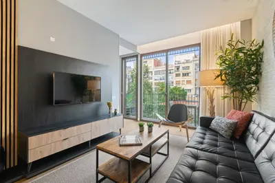 a living room with a couch and a tv at Tendency Rambla Catalunya in Barcelona