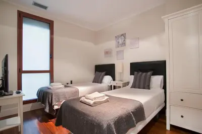 a bedroom with two beds and a window at Tendency Rambla Catalunya in Barcelona
