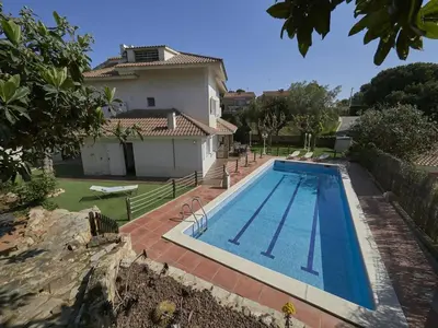 a swimming pool in front of a house at Villa Julia | 14pax. 5' sea & train in Sant Andreu de Llavaneres