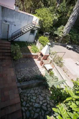 a bench sitting outside of a building with a staircase at Elis house Piscina Privada Villa Mediterránea in Castelldefels