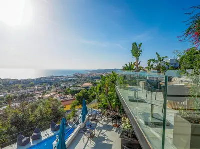a view of the ocean from the balcony of a building at Bluehillsitges - Only Adults in Sitges