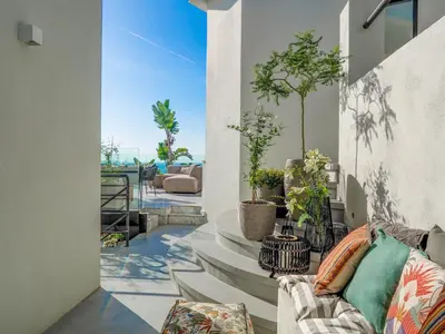 a living room with a couch and some plants at Bluehillsitges - Only Adults in Sitges