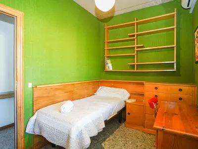 a bedroom with green walls and a bed and a table at Bed BCN Hills House in Barcelona