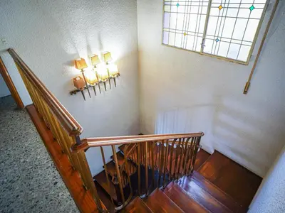 a staircase in a house with two lights on the wall at Bed BCN Hills House in Barcelona
