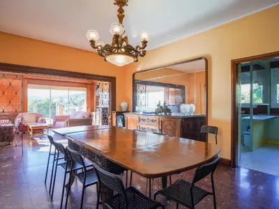 a dining room with a table and chairs at Bed BCN Hills House in Barcelona