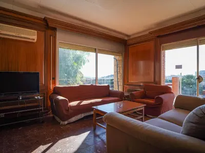 a living room with couches and a flat screen tv at Bed BCN Hills House in Barcelona