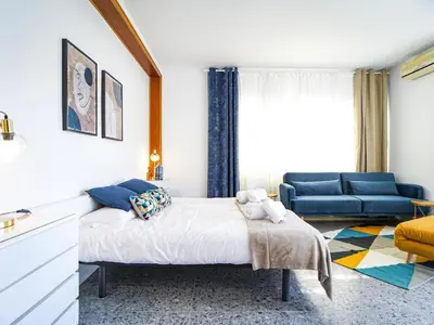 a bedroom with a bed and a blue couch at Bed BCN Hills House in Barcelona