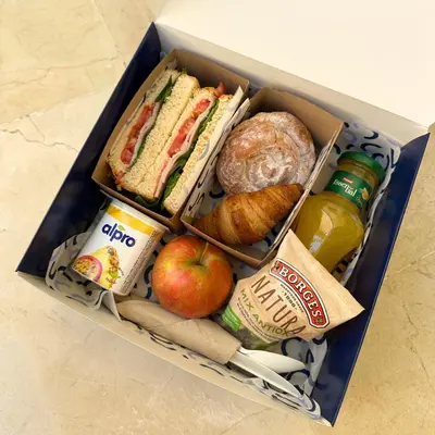 a lunch box filled with sandwiches apples and food at Numa Barcelona Brio in Barcelona