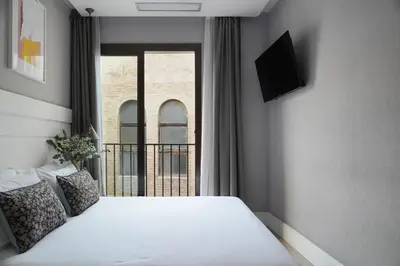 a bedroom with a white bed and a window at Numa Barcelona Brio in Barcelona