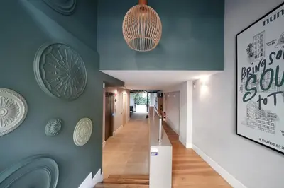 a hallway with blue walls with plates on the wall at Numa Barcelona Brio in Barcelona