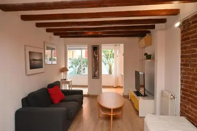 a living room with a couch and a table at Homenfun Barcelona Poblenou in Barcelona