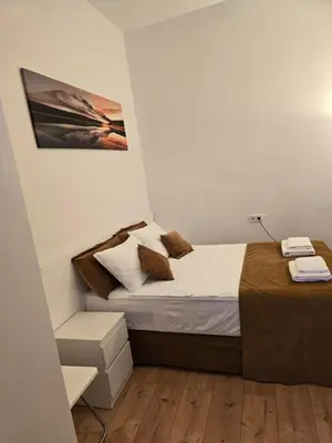 a bedroom with a bed and a picture on the wall at Casa Acogedora in Hospitalet de Llobregat