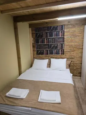 a bed in a room with two white pillows at Casa Acogedora in Hospitalet de Llobregat