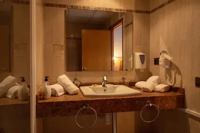 a bathroom with a sink and a mirror at Hotel Sant Celoni in San Celoni