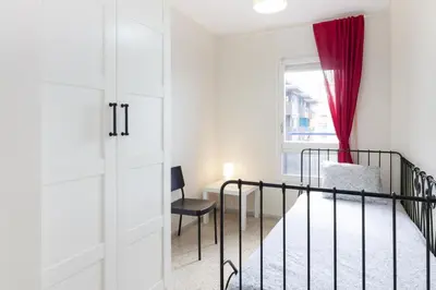 a bedroom with a bed and a window at Pubone AT Sabadell in Sabadell