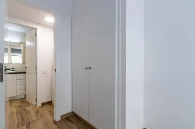 a hallway with white walls and wooden floors at Macu in Sabadell
