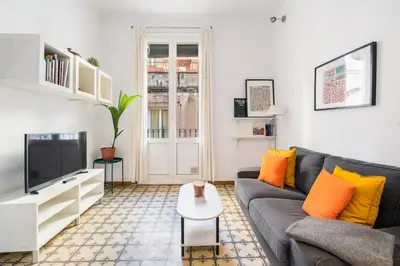 a living room with a couch and a tv at Progres in Barcelona